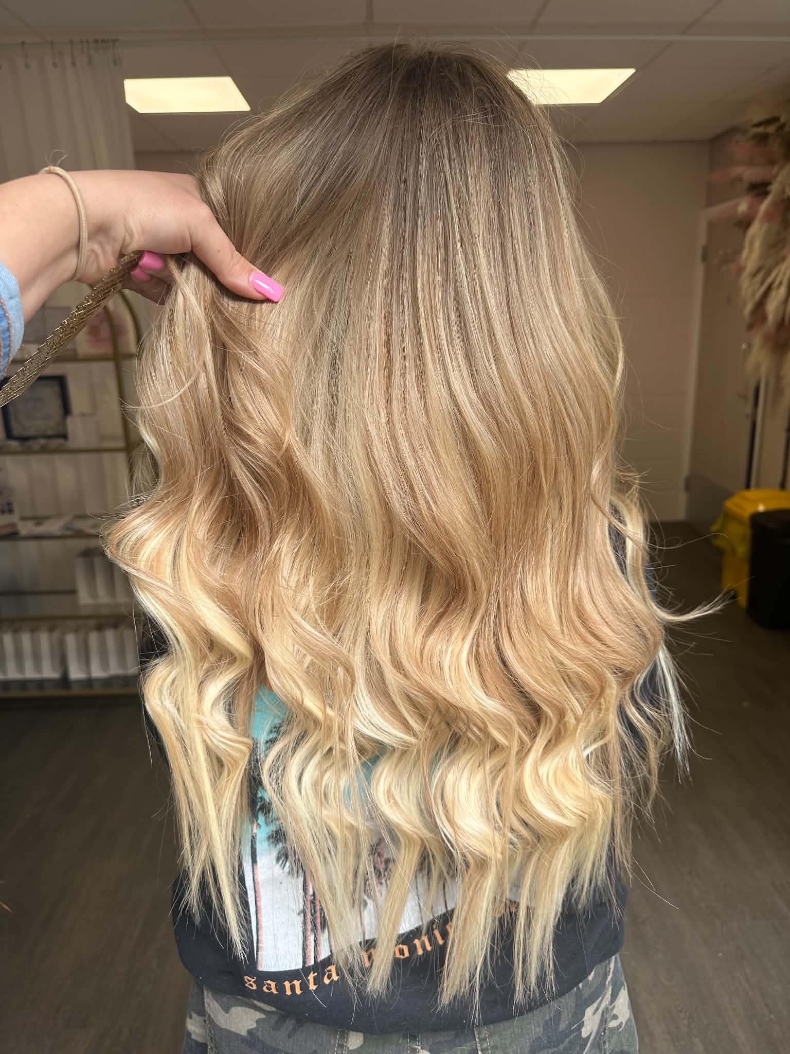 Blonde hair extension blend with soft texture and movement.